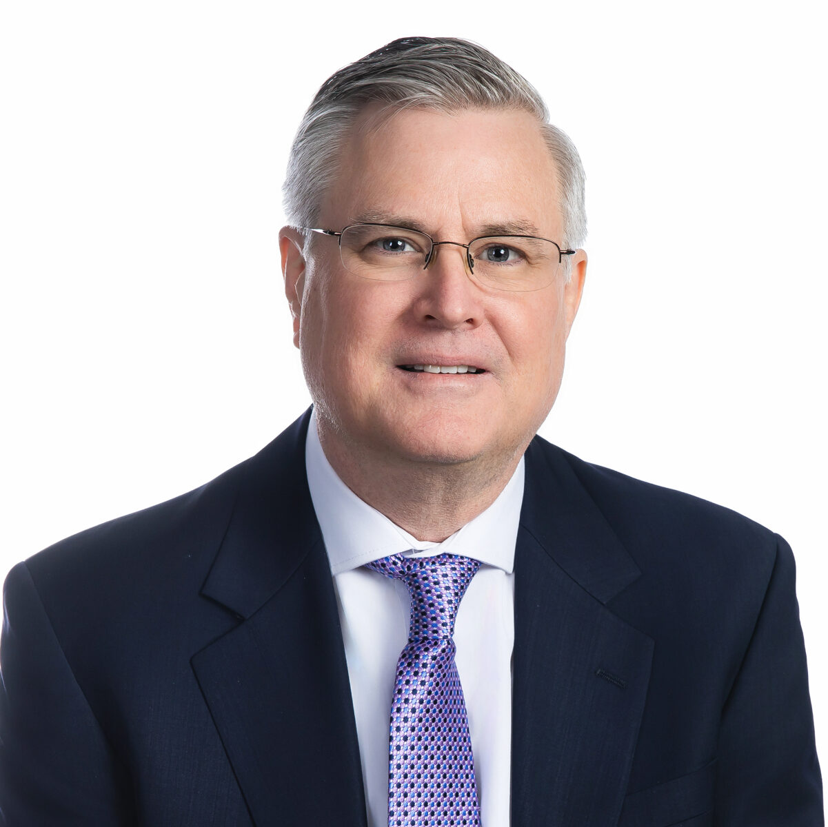 Headshot of Tim Clougherty, a middle-aged white man with a short clean haircut, brown hair with flecks of grey, and round-rimmed glasses.